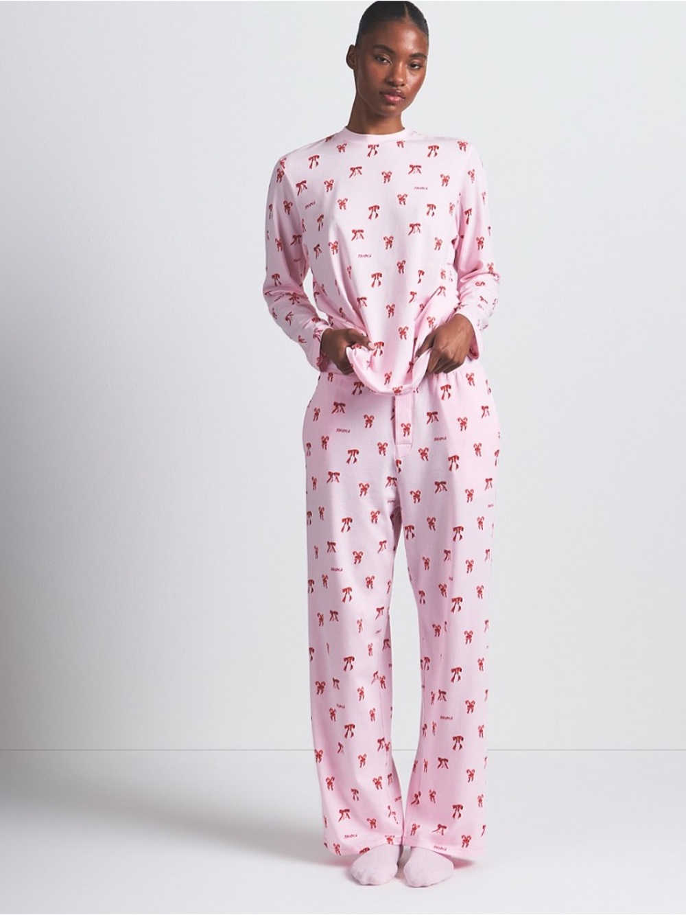 SKIMS Boyfriend Pants in candy cane print cherry blossom